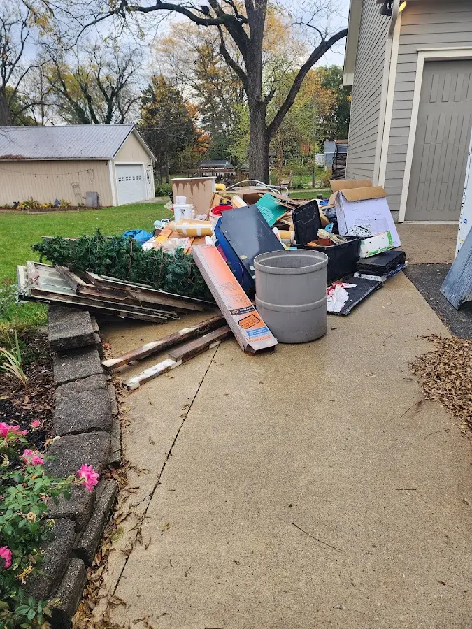 Dumpster being loaded with debris for 12 Yard Dumpster Rental in Bailey's Crossroads